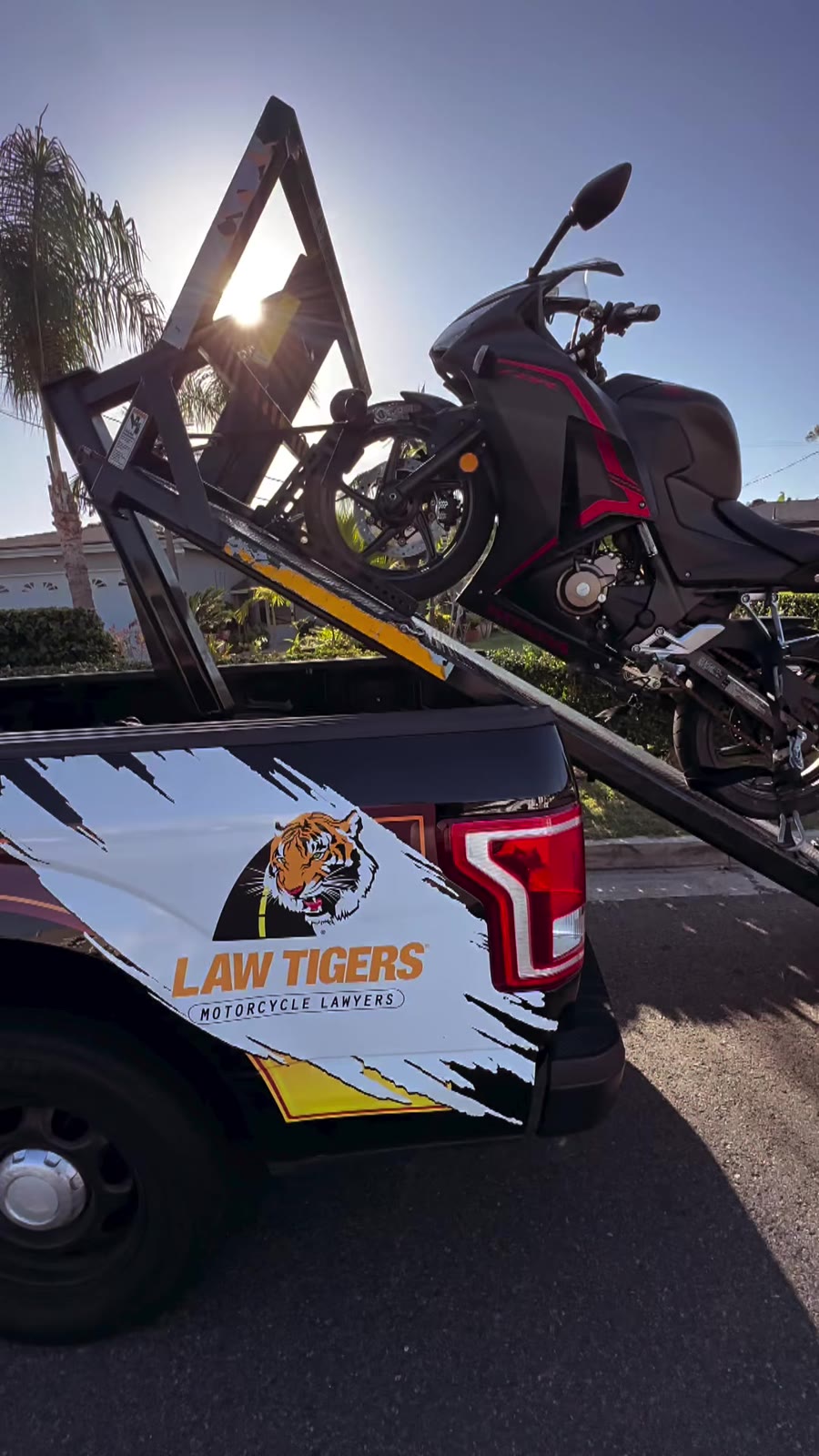 Sportbike on Law Tigers branded black truck lift