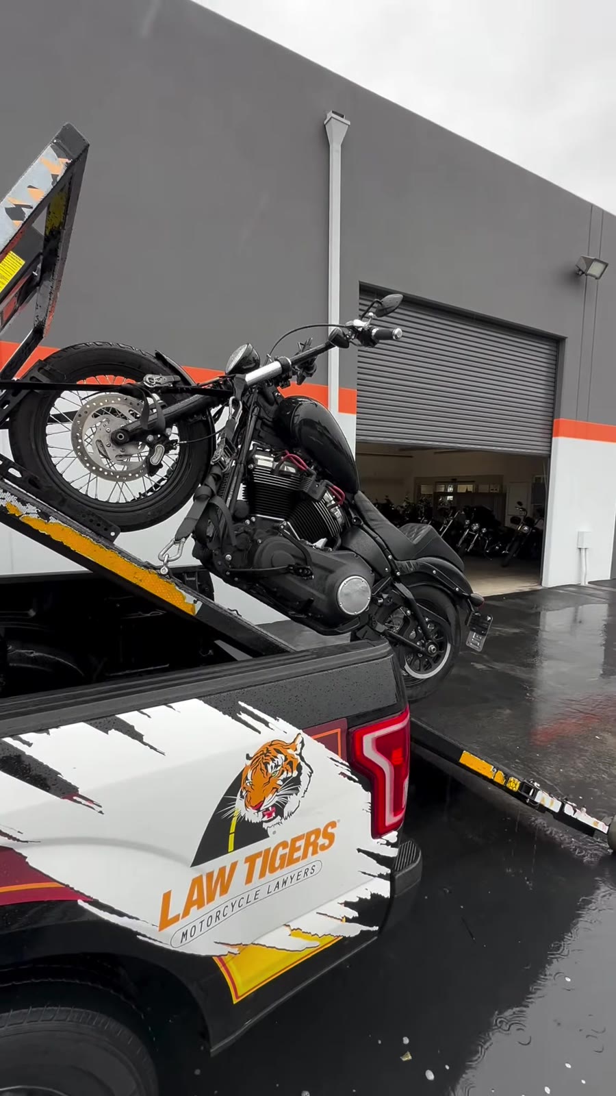 Black cruiser on Law Tigers branded black tow truck