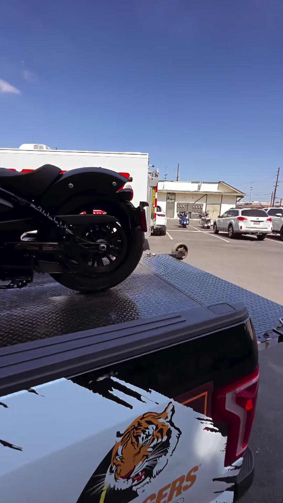 Black Indian motorcycle on Law Tigers branded black truck