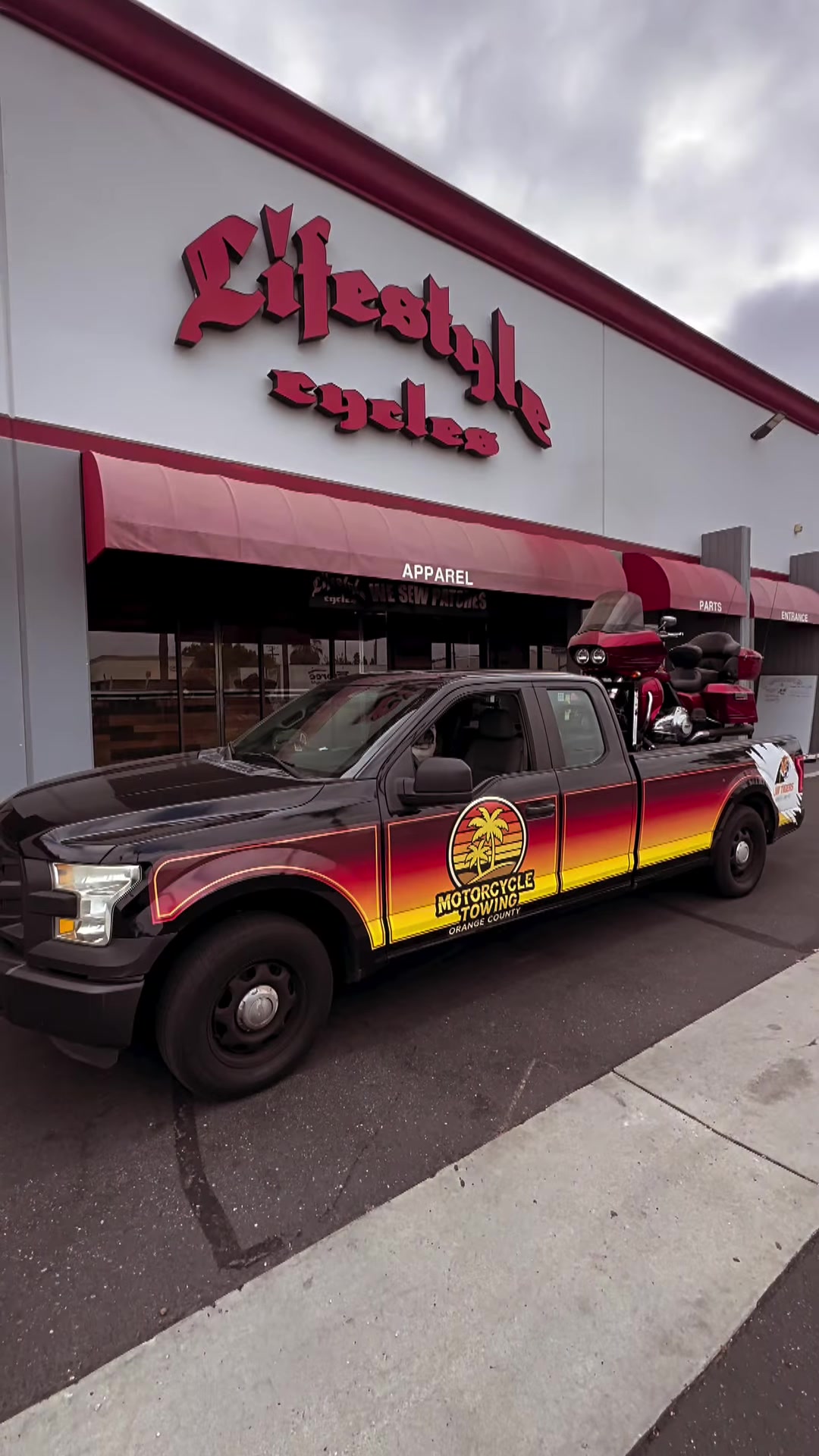 Black MC Tow OC truck with Law Tigers wrap at Lifestyle Cycles